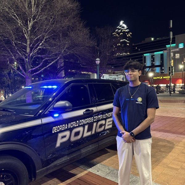 Standing next to a police cruiser